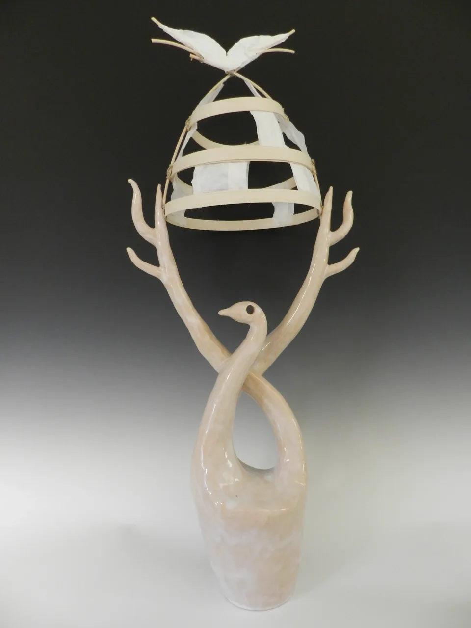 A tall open sculpture with branching pale supports.