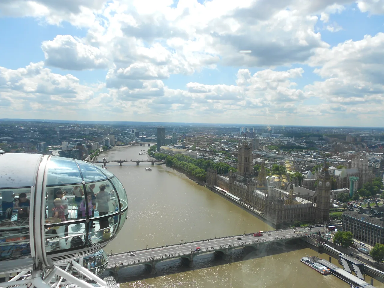 An elevated view across a river, bridges, and the city beneath clouds.