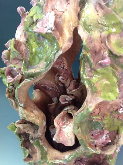 Close view of green and pink layered forms inside an organic sculpture.