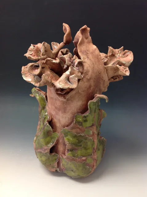 A branching organic sculpture rising from a narrow base.