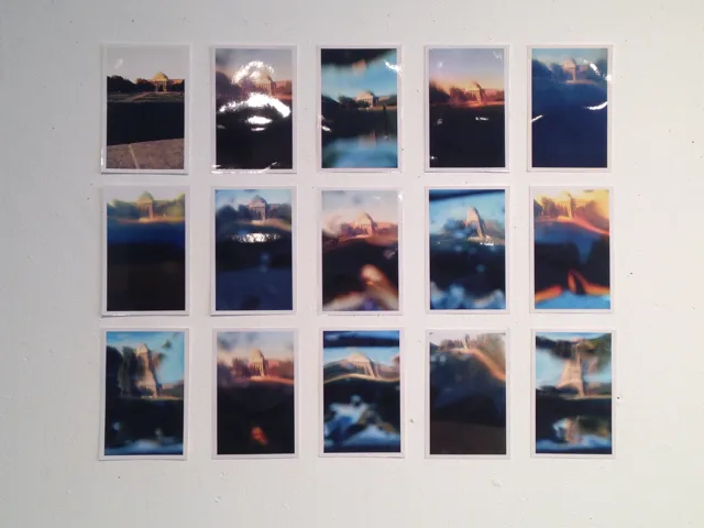 A wall-mounted grid of photographs showing variations of a domed building.
