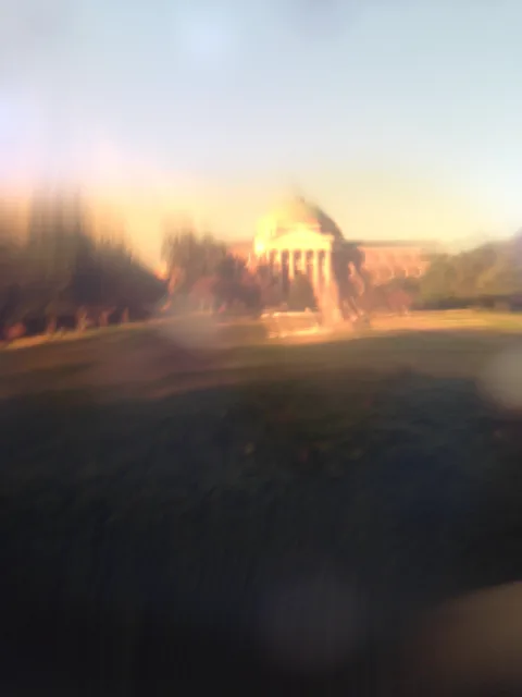 A domed building blurred in warm light.