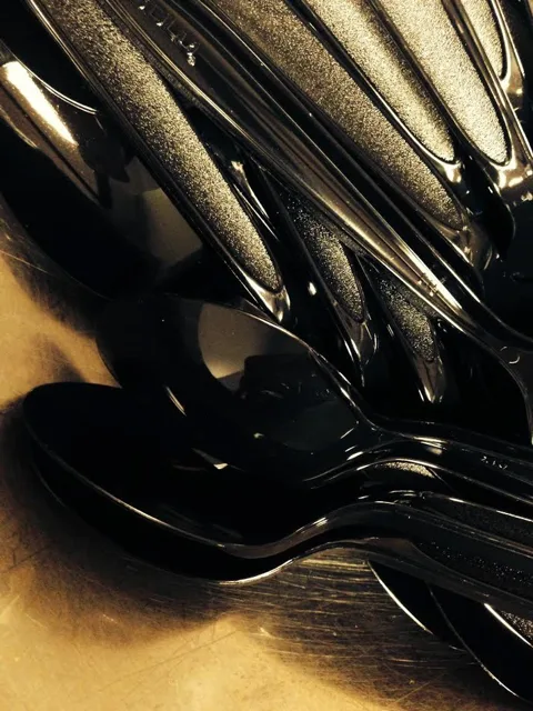 A cluster of reflective metal utensils.